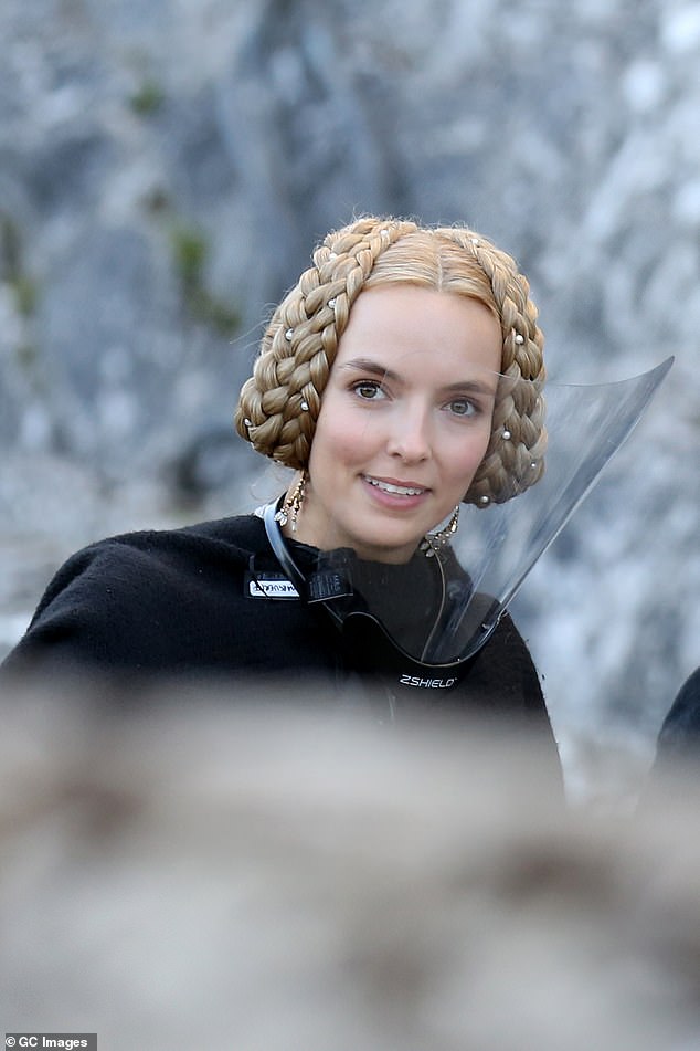 The Last Duel star Jodie Comer teams her 14th century costume with a face visor on set with Matt Damon and Adam Driver as filming finally resumes on Hollywood blockbuster in Ireland